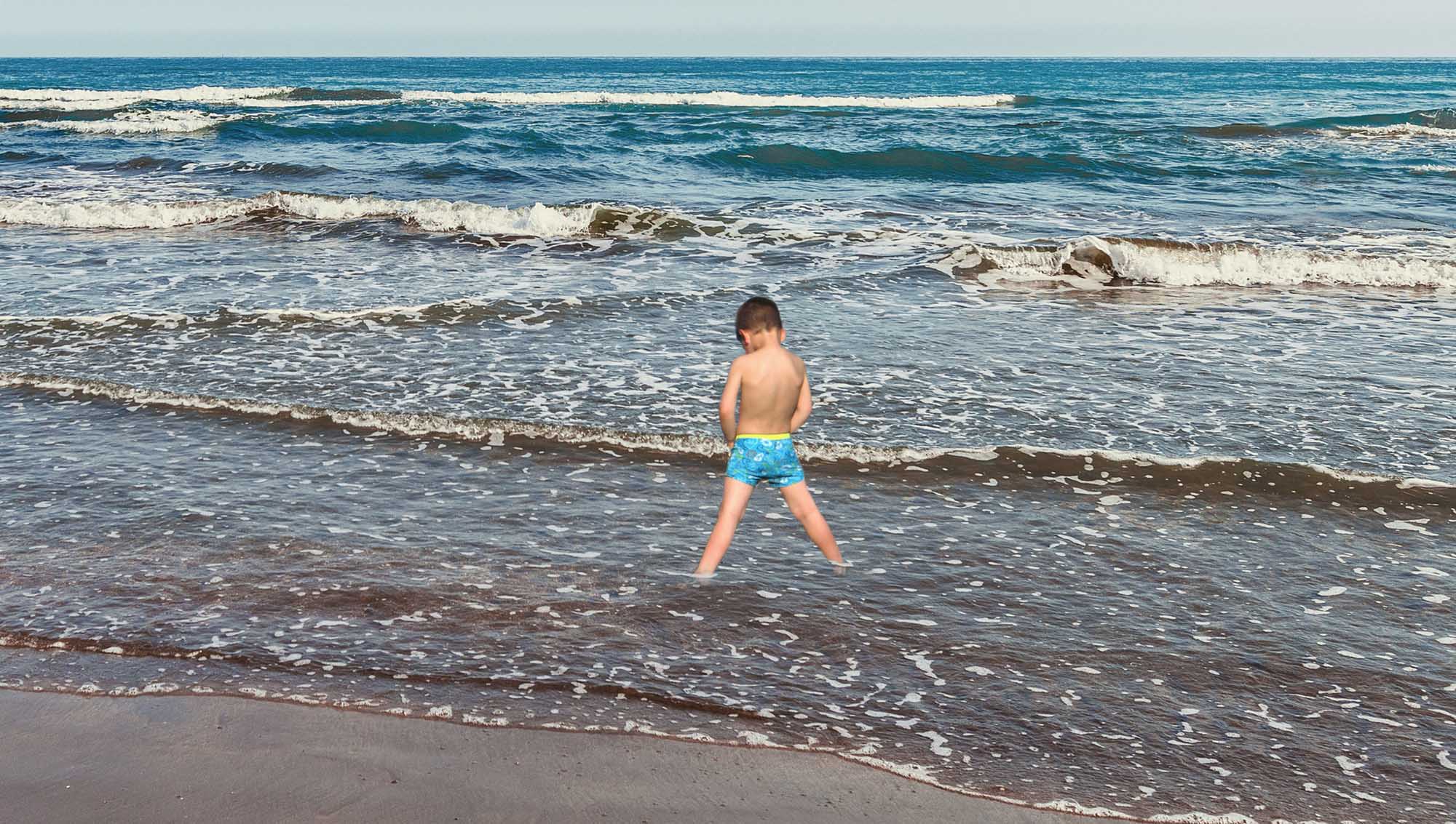 Poseidon Incarnate This Little Boy At The Beach Is Standing At The Shoreline With His Bathing Suit Down Peeing Directly Into The Waves pic